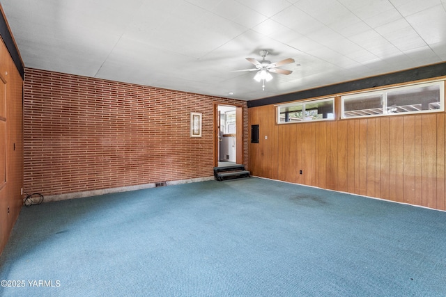 808 S 72nd Ave, Yakima, WA 98908 - carpeted empty room with ceiling fan, brick wall, and wooden walls