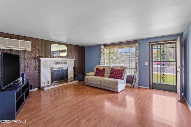 808 S 72nd Ave, Yakima, WA 98908 - living room featuring a fireplace, wood finished floors, wooden walls, and baseboards