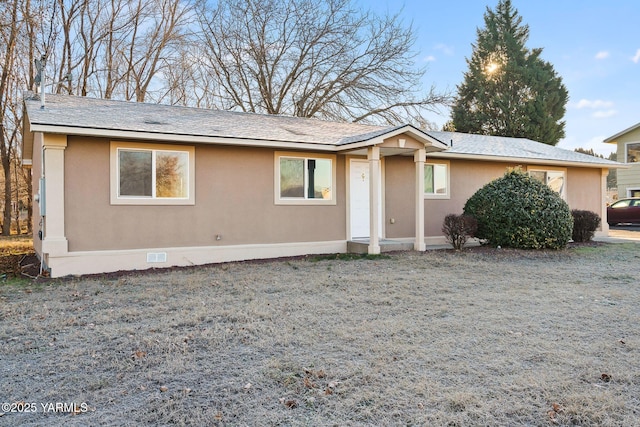 ranch-style home with crawl space, a front yard, and stucco siding