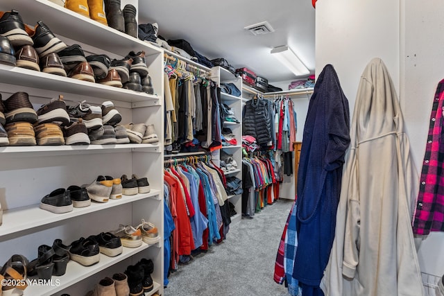 spacious closet featuring visible vents and light colored carpet