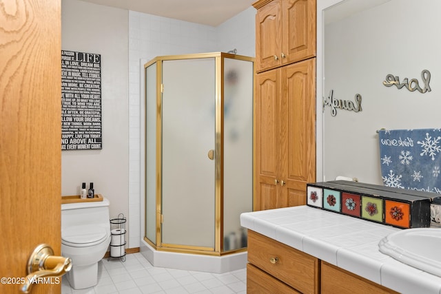 bathroom with toilet, a stall shower, vanity, and tile patterned floors