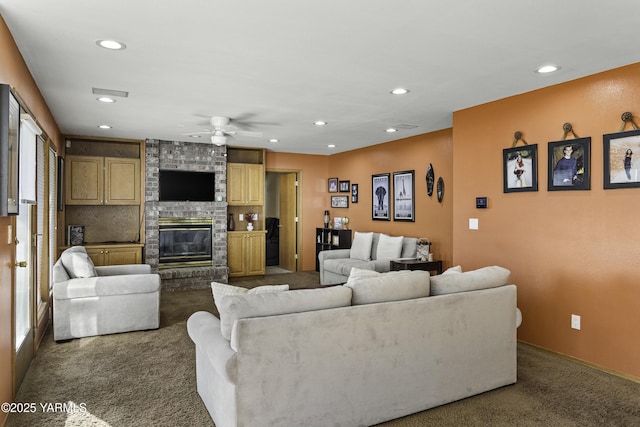 living area with a fireplace, recessed lighting, visible vents, dark carpet, and ceiling fan