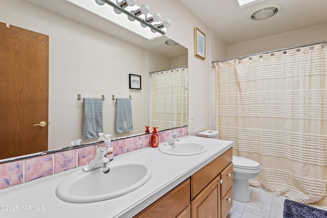 full bathroom with visible vents, a sink, toilet, and double vanity