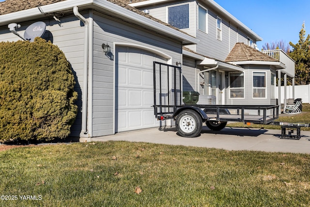 exterior space featuring a garage and a yard