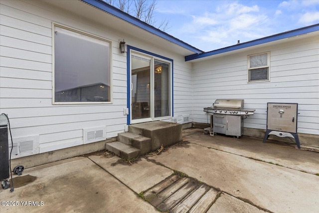 view of patio featuring entry steps, grilling area, and visible vents