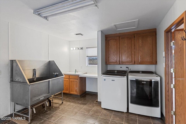 laundry area with cabinet space, a sink, washing machine and clothes dryer, and tile patterned floors