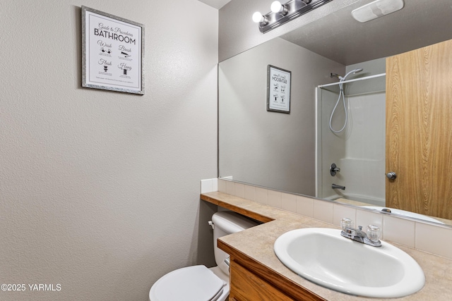 bathroom with shower / bath combination, vanity, and toilet