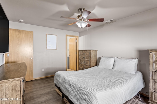 bedroom featuring visible vents, a ceiling fan, baseboards, and wood finished floors