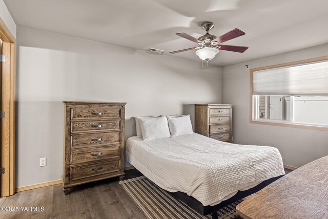 bedroom featuring baseboards, dark wood-style flooring, ceiling fan, and visible vents