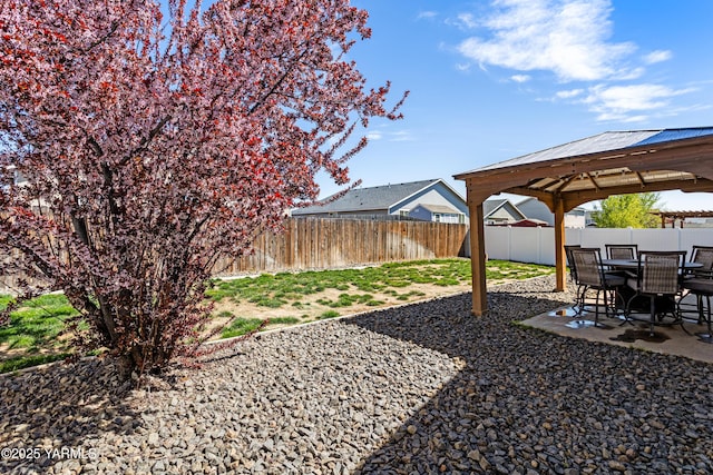 view of yard featuring a patio, a gazebo, and a fenced backyard