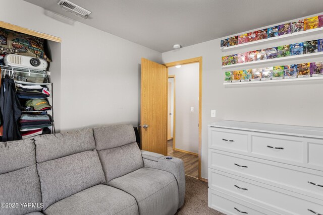 living room with baseboards, light carpet, and visible vents