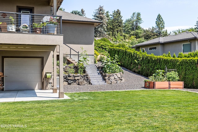 5506 Marilane St, Yakima, WA 98908 - view of grassy yard with stairway, a garage, and a balcony