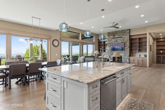 5506 Marilane St, Yakima, WA 98908 - kitchen with stainless steel dishwasher, a ceiling fan, light wood finished floors, open floor plan, and recessed lighting