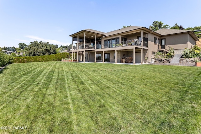 5506 Marilane St, Yakima, WA 98908 - back of house featuring a yard, stucco siding, a patio area, and a balcony