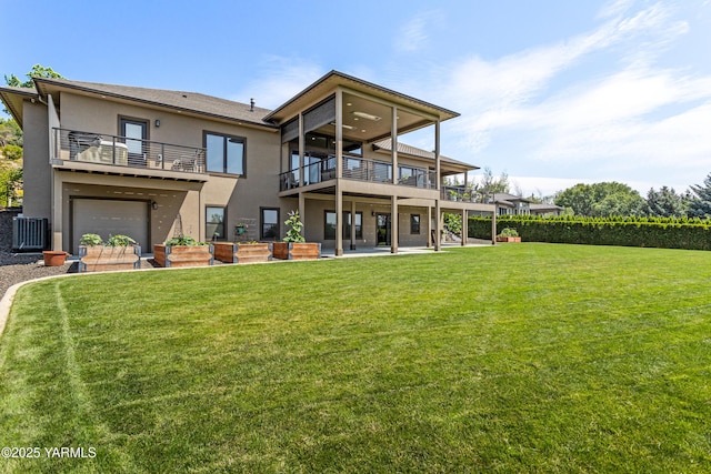 5506 Marilane St, Yakima, WA 98908 - rear view of house with stucco siding, a yard, a balcony, and an attached garage