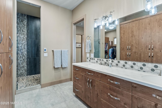 5506 Marilane St, Yakima, WA 98908 - full bathroom featuring a shower stall, double vanity, a walk in closet, and tile patterned floors