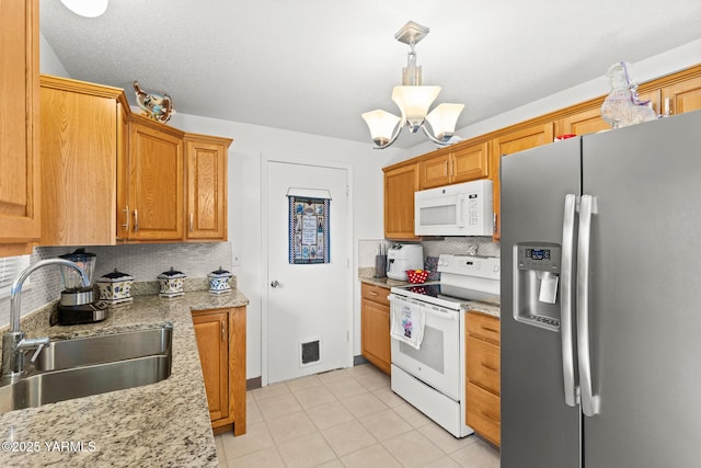 7610 Summitview Ave Unit 6, Yakima, WA 98908 - kitchen featuring white appliances, a sink, tasteful backsplash, a chandelier, and light tile patterned flooring