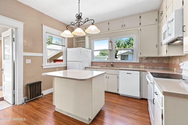 14 N 37th Ave, Yakima, WA 98902 - kitchen with white appliances, radiator, backsplash, light wood-style flooring, and light countertops