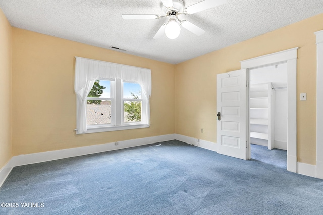 14 N 37th Ave, Yakima, WA 98902 - unfurnished bedroom with carpet, a textured ceiling, a walk in closet, and ceiling fan