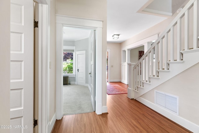 14 N 37th Ave, Yakima, WA 98902 - entryway featuring light wood-type flooring, radiator heating unit, stairs, and ornamental molding