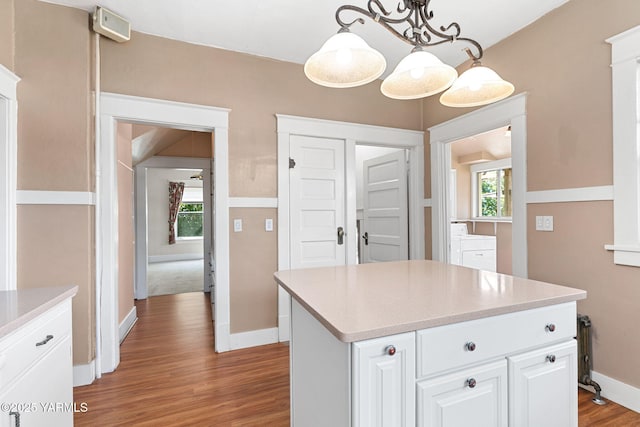14 N 37th Ave, Yakima, WA 98902 - kitchen with light wood finished floors, light countertops, white cabinets, decorative light fixtures, and a center island