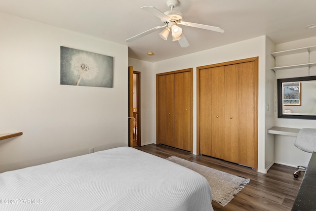 191 Alteejen Rd, Zillah, WA 98953 - bedroom featuring ceiling fan, built in desk, two closets, baseboards, and wood finished floors