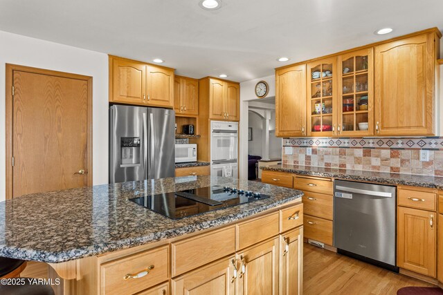 191 Alteejen Rd, Zillah, WA 98953 - kitchen with glass insert cabinets, recessed lighting, dark stone counters, light wood-style flooring, and stainless steel appliances