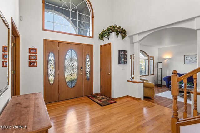 191 Alteejen Rd, Zillah, WA 98953 - entrance foyer with arched walkways, wood finished floors, a towering ceiling, ornate columns, and stairway