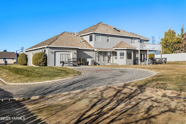 191 Alteejen Rd, Zillah, WA 98953 - back of property featuring a lawn, a garage, fence, and a balcony