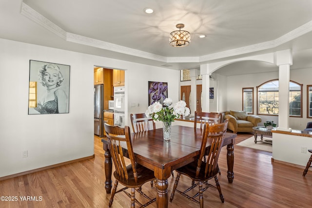 191 Alteejen Rd, Zillah, WA 98953 - dining space featuring crown molding, light wood finished floors, arched walkways, baseboards, and ornate columns
