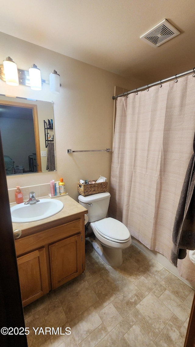 6402 Crestfields Rd, Yakima, WA 98908 - full bath with toilet, vanity, stone finish flooring, and a shower with shower curtain
