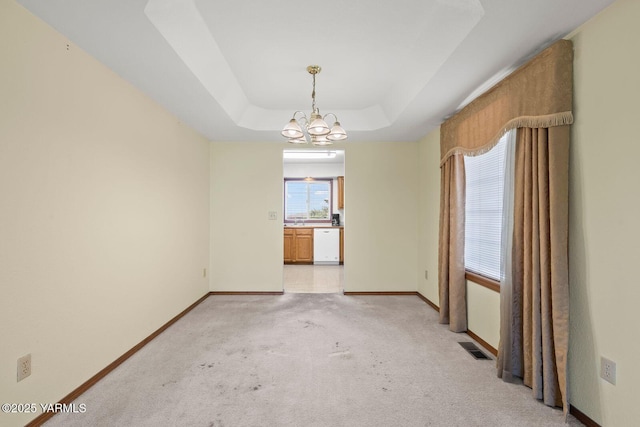 5304 Channel Dr, Yakima, WA 98901 - unfurnished room featuring a chandelier, light colored carpet, and a tray ceiling