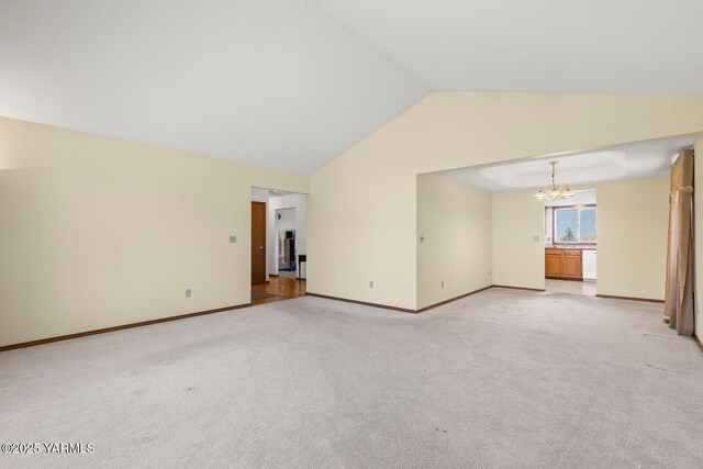 5304 Channel Dr, Yakima, WA 98901 - unfurnished living room with a chandelier, lofted ceiling, and light colored carpet