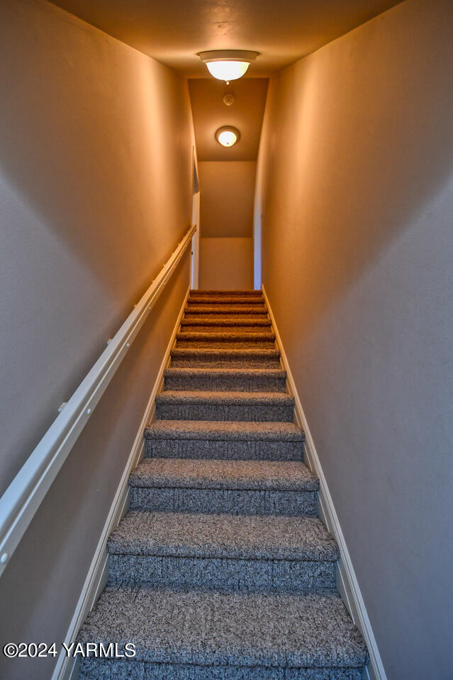 stairway featuring baseboards