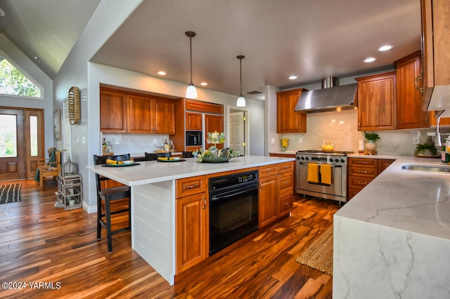 kitchen featuring a kitchen island, decorative light fixtures, high end stove, wall chimney range hood, and black oven