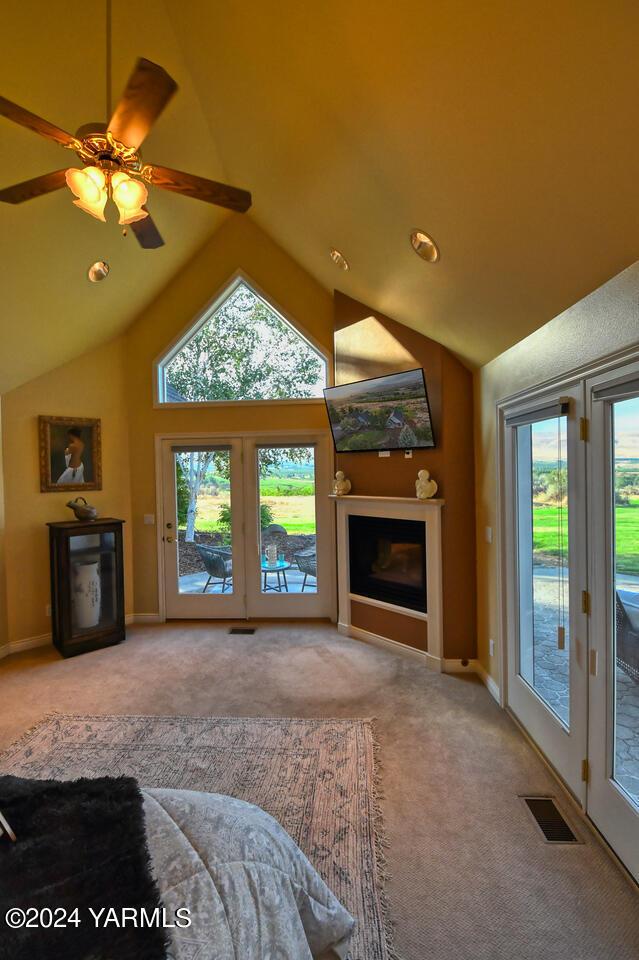 unfurnished living room featuring a fireplace, visible vents, a wealth of natural light, and carpet flooring