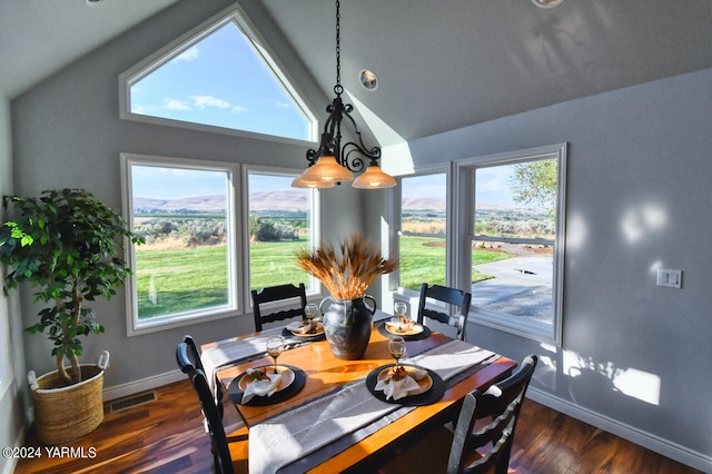 15783 Fisk Rd, Yakima, WA 98908 - dining area with vaulted ceiling, baseboards, healthy amount of natural light, and dark wood-style flooring