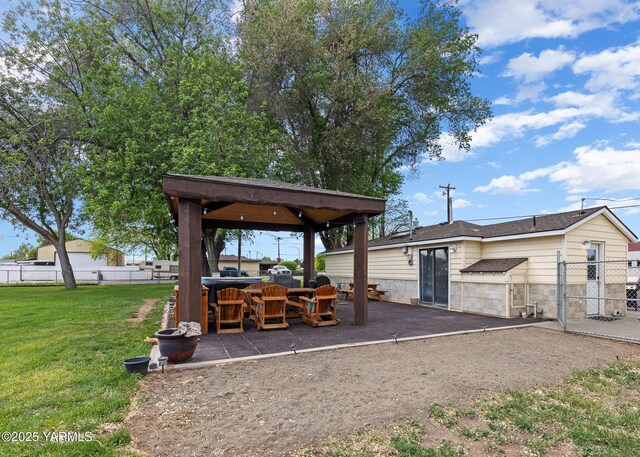 view of yard featuring a gazebo, a patio area, and a gate