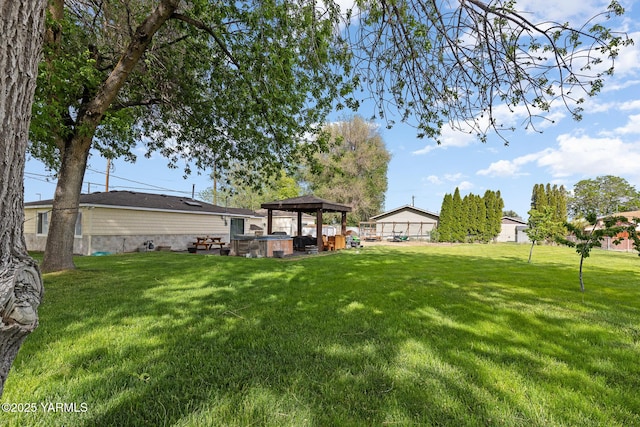 view of yard with a hot tub and a gazebo