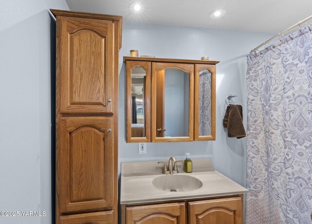 bathroom featuring vanity and curtained shower