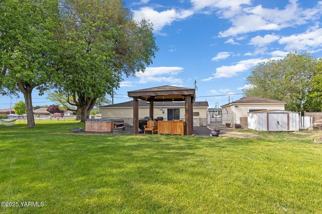 rear view of property with a hot tub, a storage shed, an outdoor structure, and a gazebo