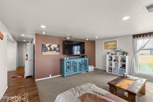living area with recessed lighting, baseboards, and wood finished floors