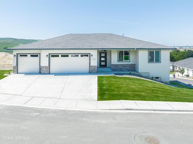 view of front of house with a garage, concrete driveway, stone siding, roof with shingles, and a front lawn