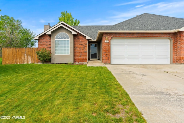 2 N 74th Ave, Yakima, WA 98908 - view of front of house featuring a chimney, driveway, brick siding, and a garage