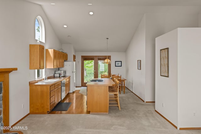2 N 74th Ave, Yakima, WA 98908 - kitchen featuring a sink, high vaulted ceiling, a kitchen breakfast bar, baseboards, and a kitchen island
