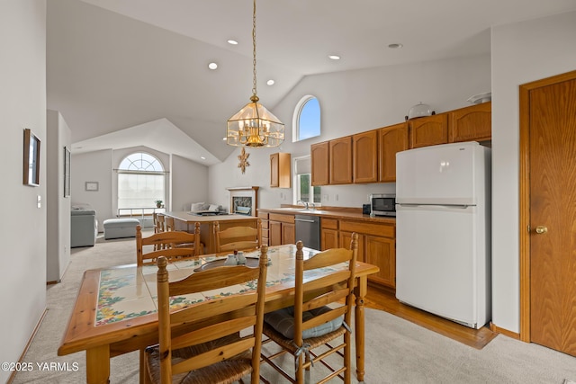 2 N 74th Ave, Yakima, WA 98908 - kitchen featuring appliances with stainless steel finishes, a sink, lofted ceiling, a chandelier, and brown cabinetry