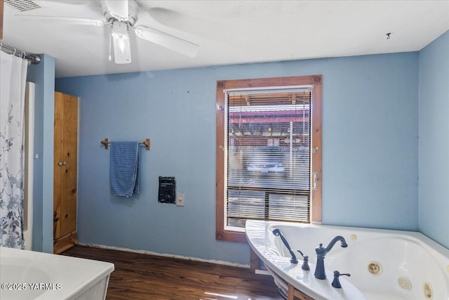 101 W Slavin Rd, Yakima, WA 98903 - bathroom with a tub with jets, wood finished floors, ceiling fan, and vanity