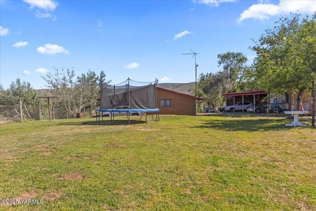 101 W Slavin Rd, Yakima, WA 98903 - view of green lawn with a trampoline and a carport