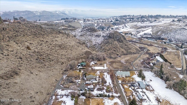 snowy aerial view featuring a mountain view