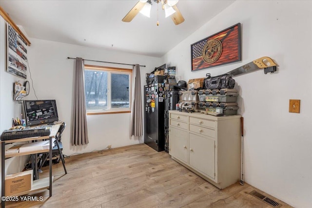 kitchen with light countertops, visible vents, light wood-style flooring, cream cabinets, and a ceiling fan